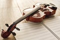 Visual beauty of classical instrument. Close up view of brown beautiful violin lying on sheets for music notes over Royalty Free Stock Photo