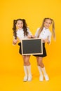 Visual communication. Girls school uniform hold blackboard. Back to school concept. Upcoming events in school. Glad to