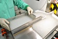 Visual control of ampoules with medicine. A woman works on an ampoule production line. Sterile bottles and ampoules on Royalty Free Stock Photo