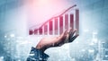 Business Growth Concept with Hand Holding Graph in Modern Cityscape Background for Financial Success and Development Royalty Free Stock Photo