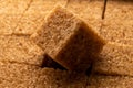 A visual representation of the food crisis, as an full pack of brown sugar cubes in the background symbolizes the