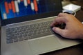 Visualizing Market Patterns: Close-Up View of a Laptop and Keyboard Displaying Candlestick Chart