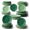 Collection of green ceramic dinner plates arranged in stacks and displayed on a stand isolated on white background Royalty Free Stock Photo