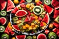 A visually appealing display of a fresh fruit platter, featuring slices of watermelon, pineapple, kiwi, and other seasonal fruits