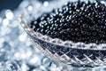 A visually appealing glass bowl filled with black beads adds a touch of sophistication to any table setting, A close-up view of