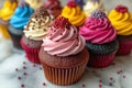 A visually appealing row of expertly decorated cupcakes sitting on top of a counter