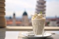 A visually appealing shot of a panna cotta dessert, with the historic Leaning Tower of Pisa gently out of focus in the backdrop.