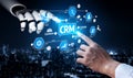 Futuristic Robot Hand and Human Hand Interacting with CRM Technology in a Digital Business Environment Against a Royalty Free Stock Photo
