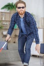 visually impaired man using stick to move around home Royalty Free Stock Photo