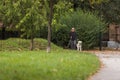 Visually impaired woman walking in park with a guide dog assistance Royalty Free Stock Photo