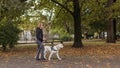 Visually impaired woman walking in park with a guide dog assistance Royalty Free Stock Photo