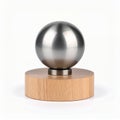 Minimalist composition of metal sphere on wooden base creating a subtle contrast on white background Royalty Free Stock Photo