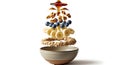Delicious layered breakfast cereal with fruit and nuts suspended above a bowl isolated on white background Royalty Free Stock Photo