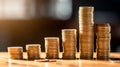 Stacked shiny golden coins of different value on wooden table, finances, investment, stock, savings concept Royalty Free Stock Photo