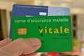 Vitale card and European health insurance card held in hand close up