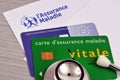 Vitale card and European health insurance card with a stethoscope close-up on a health insurance sheet