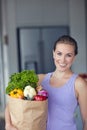 Vitality is about feeding your body with healthy foods. Portrait of a young attractive woman carrying a bag of groceries Royalty Free Stock Photo