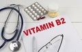 VITAMIN B2 word with Stethoscope on keyboard on grey background