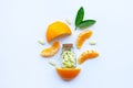 Vitamin C bottle and pills with orange fruit on white Royalty Free Stock Photo