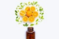 Vitamin C bottle and pills with orange fruit on white Royalty Free Stock Photo