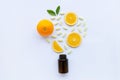 Vitamin C bottle and pills with orange fruit on white Royalty Free Stock Photo