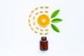 Vitamin C bottle and pills with orange fruit on white Royalty Free Stock Photo