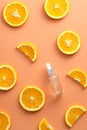 Vitamin c serum dropper bottle with sliced orange top view. Natural organic product, beauty and spa concept