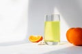 Vitamin C soluble effervescent tablets in a glass of water. Orange. The drink enhances immunity and resistance to