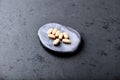 Vitamin C tablets on dark stone background. Soft focus. Royalty Free Stock Photo
