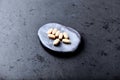 Vitamin C tablets on dark stone background. Soft focus. Royalty Free Stock Photo