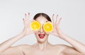 Vitamin C. A young woman holding two half oranges isolated white background Royalty Free Stock Photo