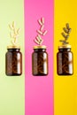 Vitamin capsules. pills in glass bottle on yellow, pink, green background with trendy shadows. Concept wellness, mental Royalty Free Stock Photo