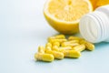 Vitamin capsules. Vitamin C pills, lemon fruit and pill bottle