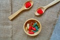 Vitamin capsules on wooden spoon. Vitamin B, C, zinc, iron, fish oil.