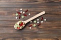 Vitamin capsules in a wooden spoon on a colored background. Pills served as a healthy meal. Drugs, pharmacy, medicine or Royalty Free Stock Photo