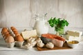 Vitamin D rich foods on a white wooden table. Natural sources of vitamin D are dairy products, salmon, egg, mushrooms, parsley,