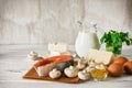 Vitamin D rich foods on a white wooden table. Natural sources of vitamin D are dairy products, salmon, egg, mushrooms, parsley,