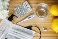 Vitamin D, vitamin C and zinc pills on wooden table with face mask, disinfection gel, lemons