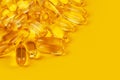 Vitamin e omega 3 fish oil yellow pills vitamins sport nutrition healthy on the yellow background isolated close up Royalty Free Stock Photo