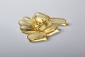 vitamin E supplement a group of 9 golden capsules on a white background