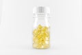 Vitamin, fish oil capsules in transparent bottle. Food supplement on white background