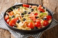 Vitamin fresh greek pasta spaghetti salad with cheese and vegetables close-up on a plate. horizontal