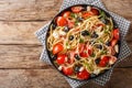 Vitamin fresh greek pasta spaghetti salad with cheese and vegetables close-up on a plate. Horizontal top view Royalty Free Stock Photo