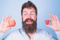 Vitamin fruit nutrition concept. Healthcare dieting vitamin. Man bearded smiling holds apple and strawberry in hands