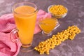 Vitamin juice from sea buckthorn and honey in a glass on a gray background. Royalty Free Stock Photo