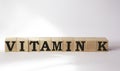 VITAMIN K. The text is on cubes and a white background. Bright solution for medicine, marketing concept Royalty Free Stock Photo