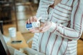 Close up of pregnant woman putting vitamin into her palm