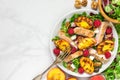 Vitamin salad with grilled chicken and peach, feta cheese, raspberries and walnuts in a plate. healthy food. top view Royalty Free Stock Photo