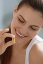 Vitamin. Smiling woman with omega 3 pill, fish oil capsule Royalty Free Stock Photo