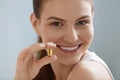 Vitamin. Smiling woman with omega 3 pill, fish oil capsule Royalty Free Stock Photo